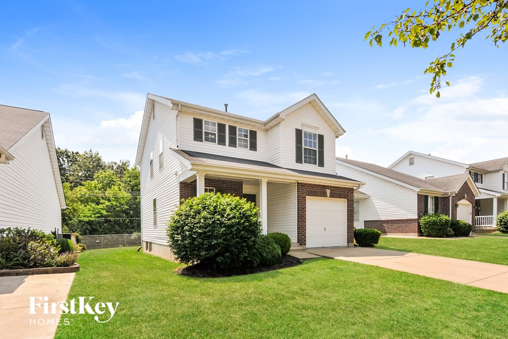 a white house with a lawn in front of it