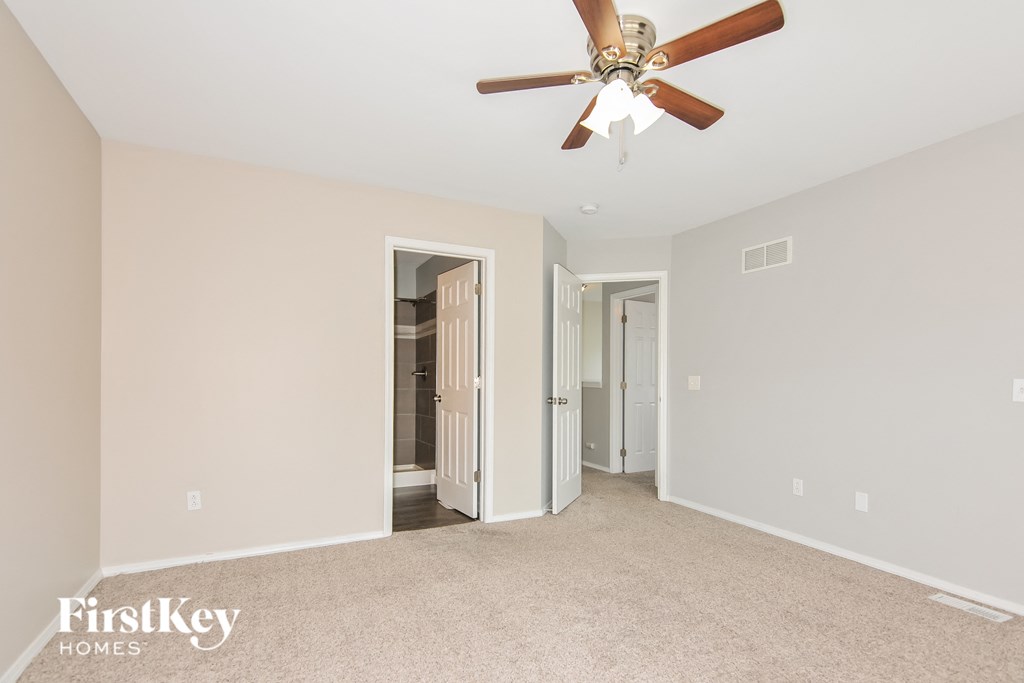 the master bedroom is spacious and has a ceiling fan