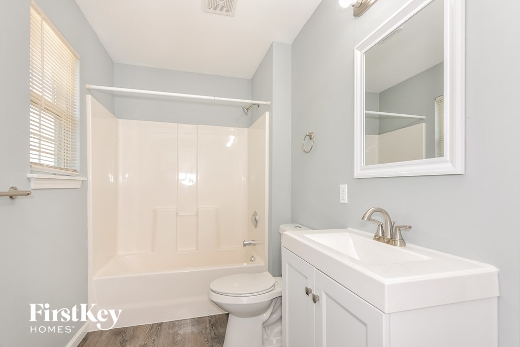 a bathroom with a sink toilet and a shower