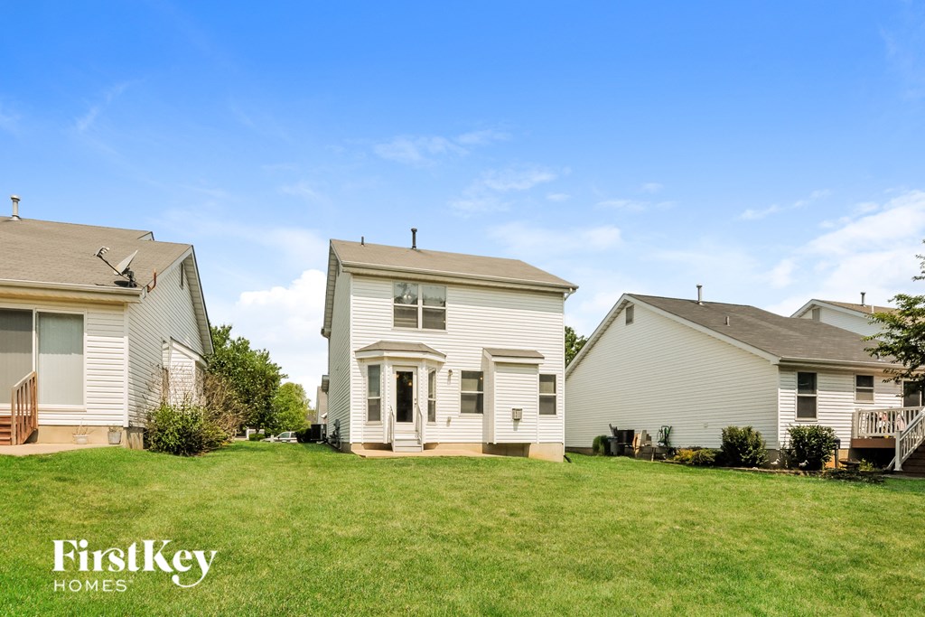 a white house with a yard in front of it
