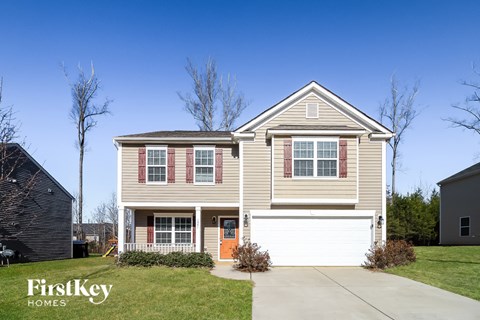 A two-story house with a garage is for sale by FirstKey Homes.