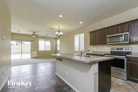 a kitchen with a sink and a stove and a microwave