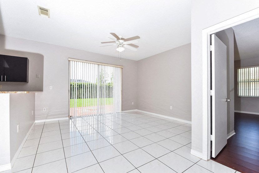 the living room has a sliding glass door to the patio
