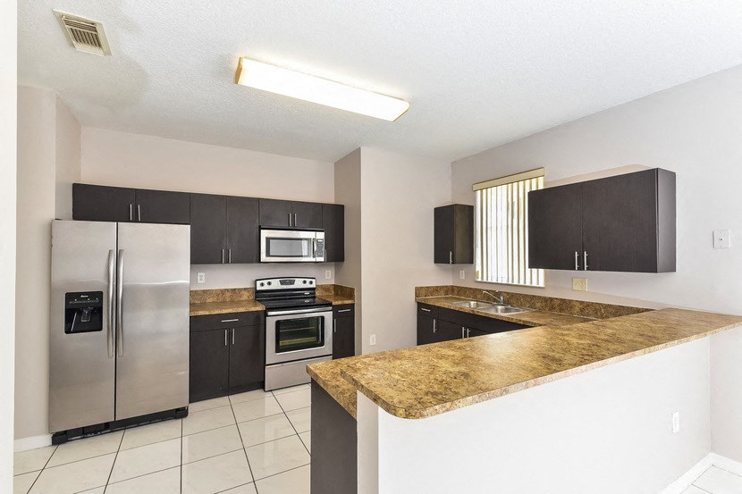 a kitchen with stainless steel appliances and a counter top