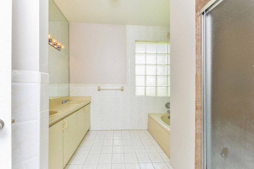 a bathroom with a tub and a sink and a shower