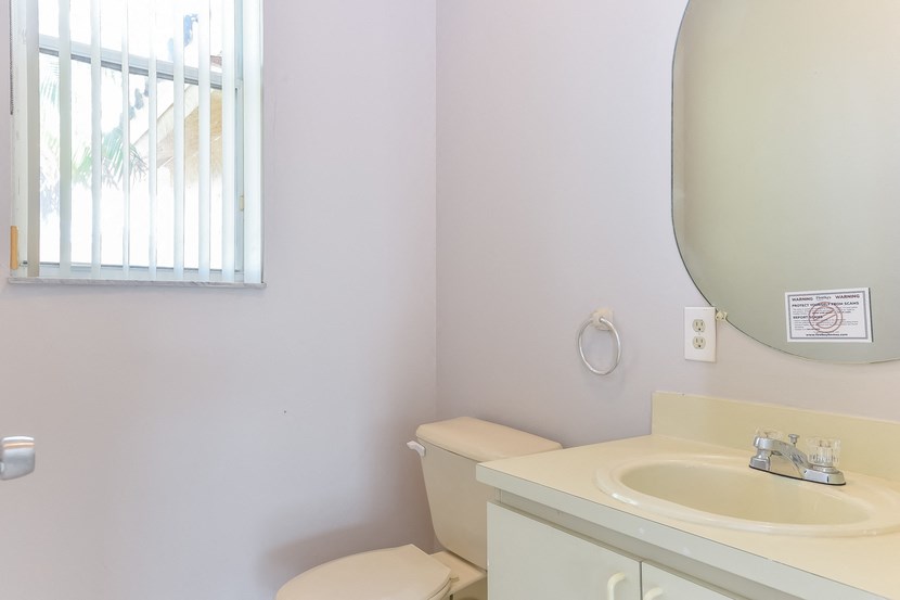 a bathroom with a sink and a toilet and a mirror