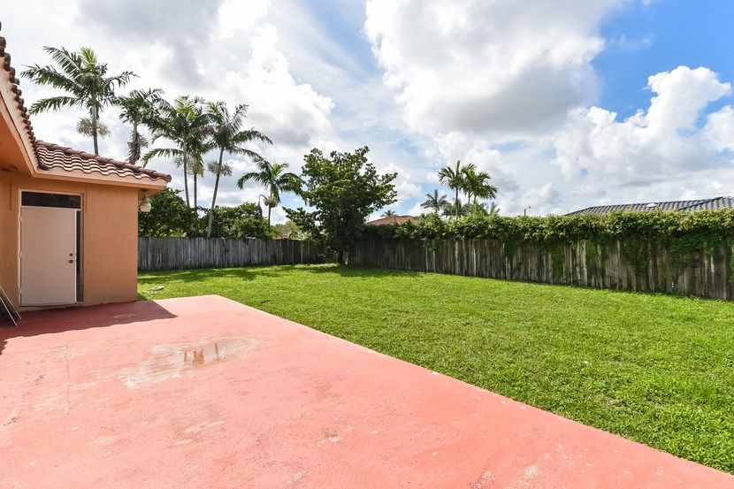 the backyard of a house with a yard and a garage