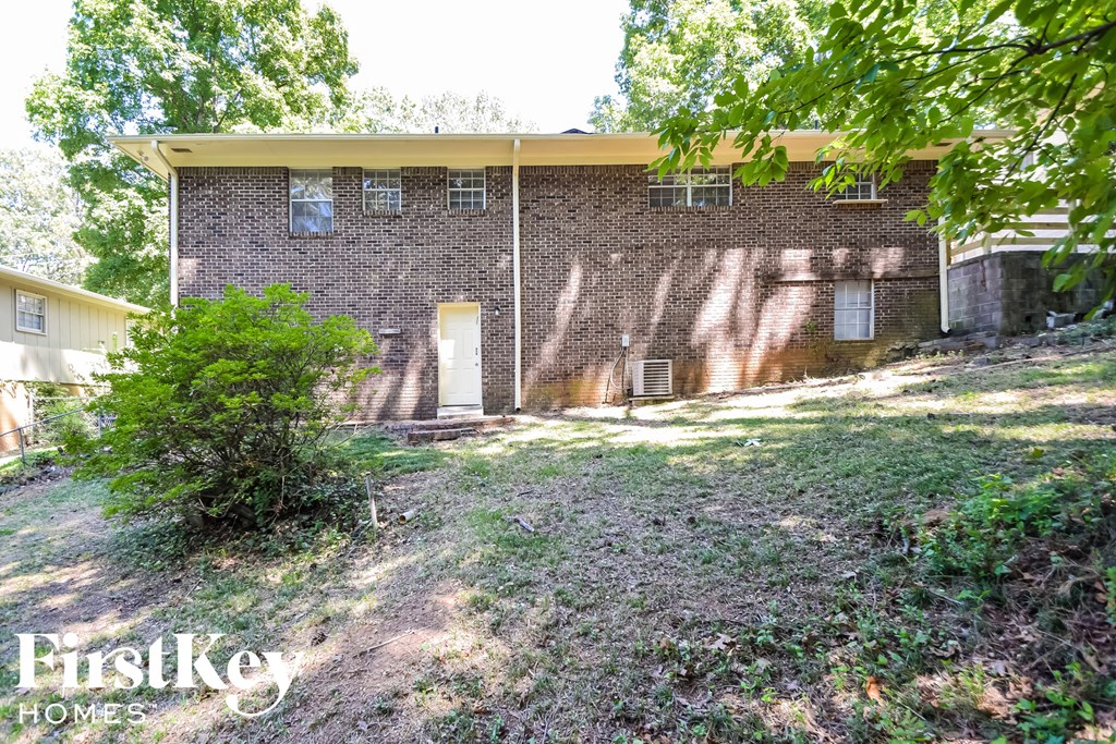 an old brick house with a yard in front of it