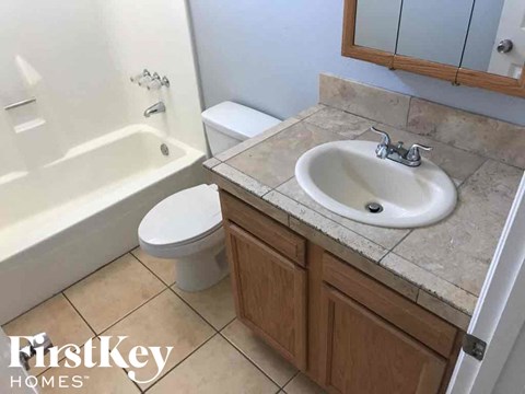 a bathroom with a sink toilet and a bath tub