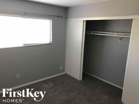 a small room with a closet and a window in it