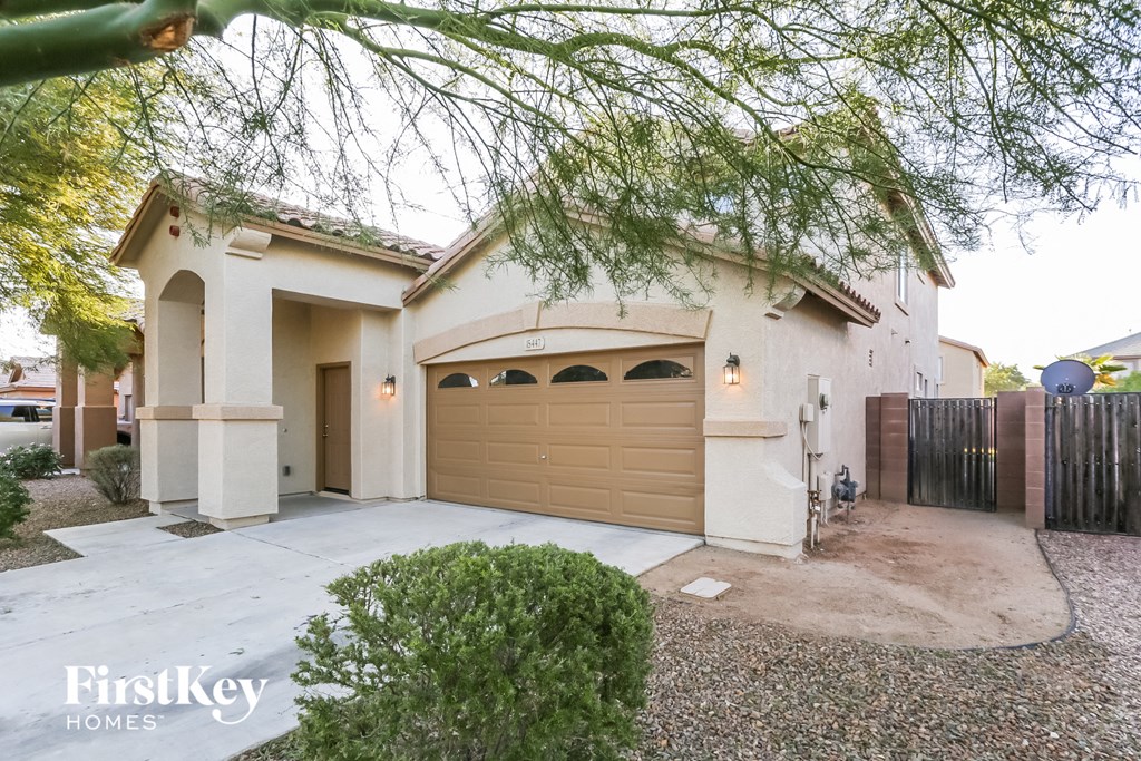 A house with a garage and a driveway is shown.