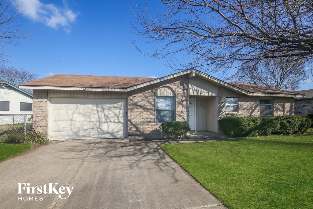 A house with a brown roof and a white garage door.