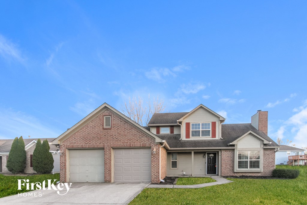 a house with a garage and a blue sky
