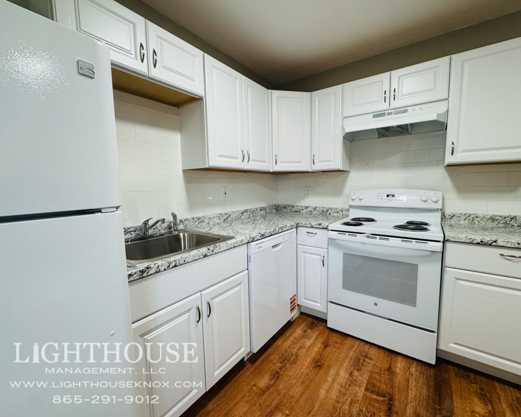 A white kitchen with Lighthouse Management written on the image.