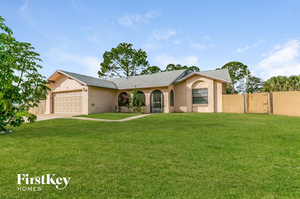 A house with a large lawn in front of it.