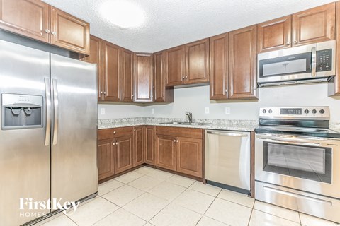A kitchen with wooden cabinets and stainless steel appliances.