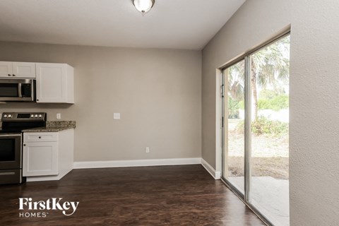 A kitchen area with a microwave and oven on the counter.