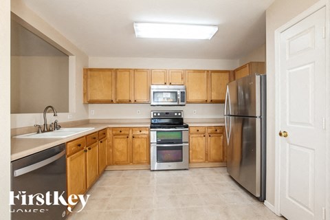 A kitchen with wooden cabinets and stainless steel appliances.