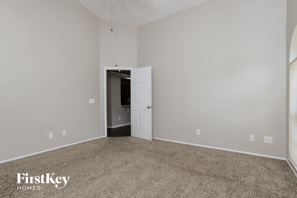 a bedroom with a carpeted floor and a white door