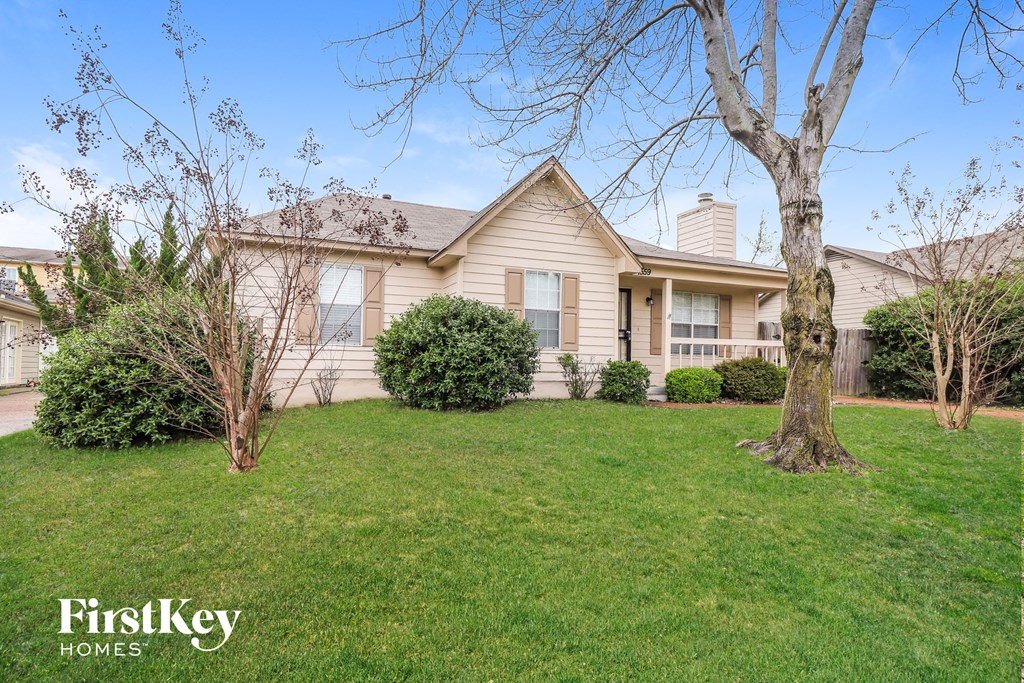 a home with a lawn and a tree