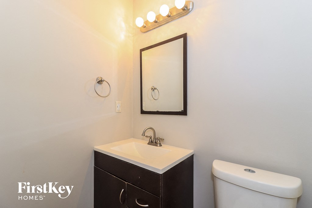 a bathroom with a sink and a mirror and a toilet