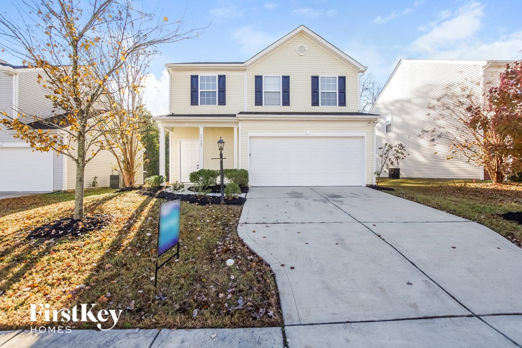 a white house with a sidewalk in front of it