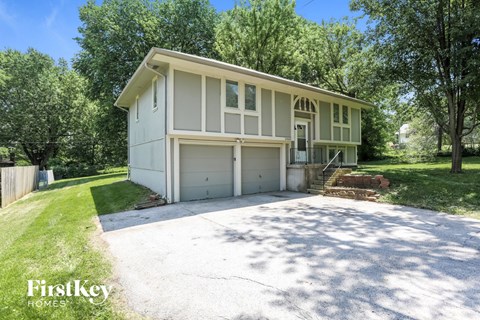 a white house with a driveway and a garage door