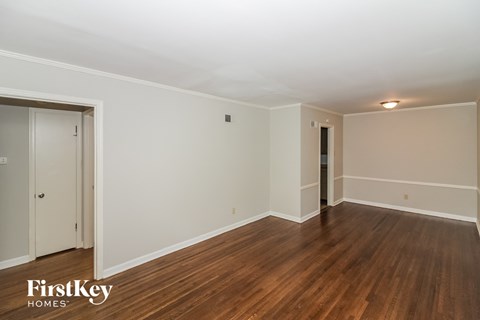 a living room with wood floors and white walls