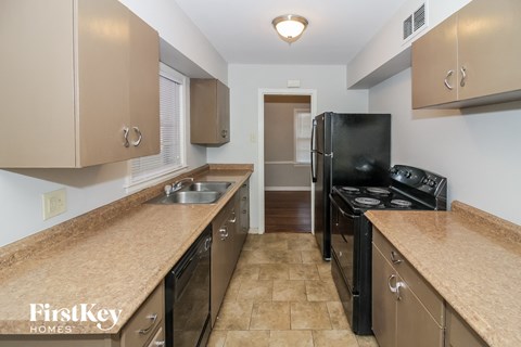a kitchen with a black stove and a black refrigerator