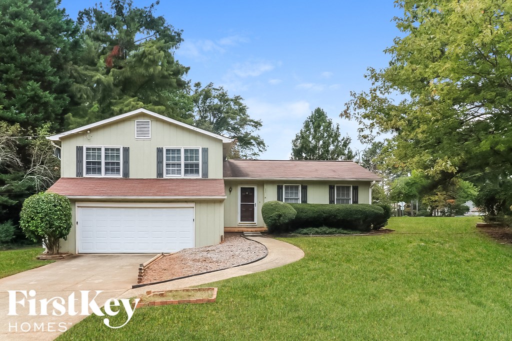 a home with a driveway and a white garage door