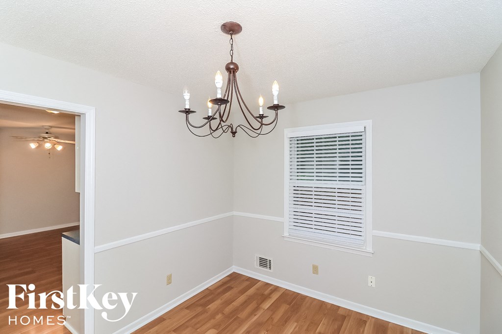 a dining room with a chandelier and a window