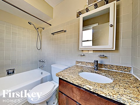 a bathroom with a sink and a toilet and a bath tub