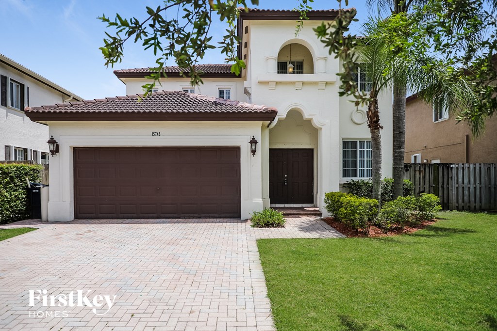 A house with a brown garage door is for sale.