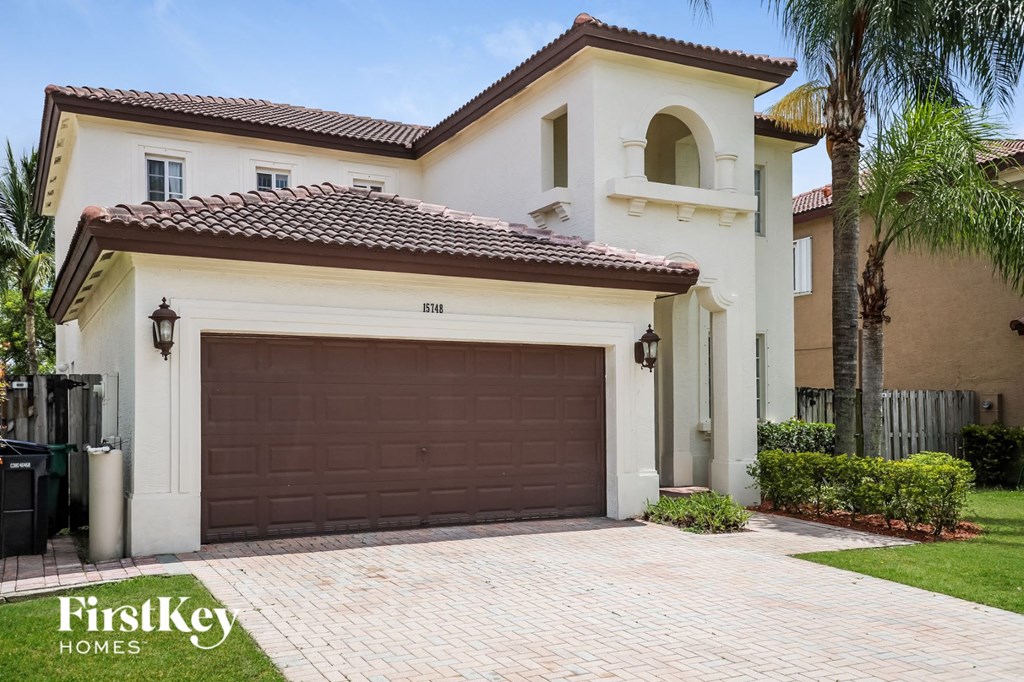 A house with a brown garage door is for sale.