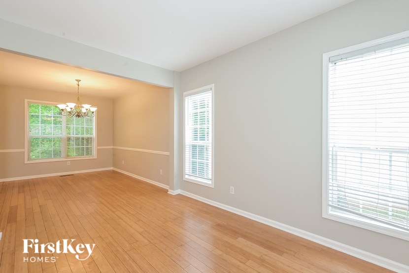 A room with wooden floors and a chandelier.