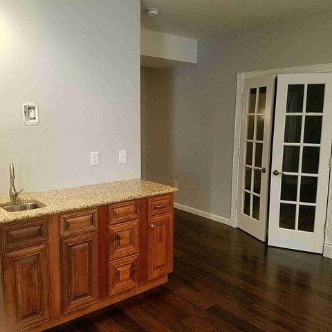 A kitchen with wooden cabinets and a granite countertop.