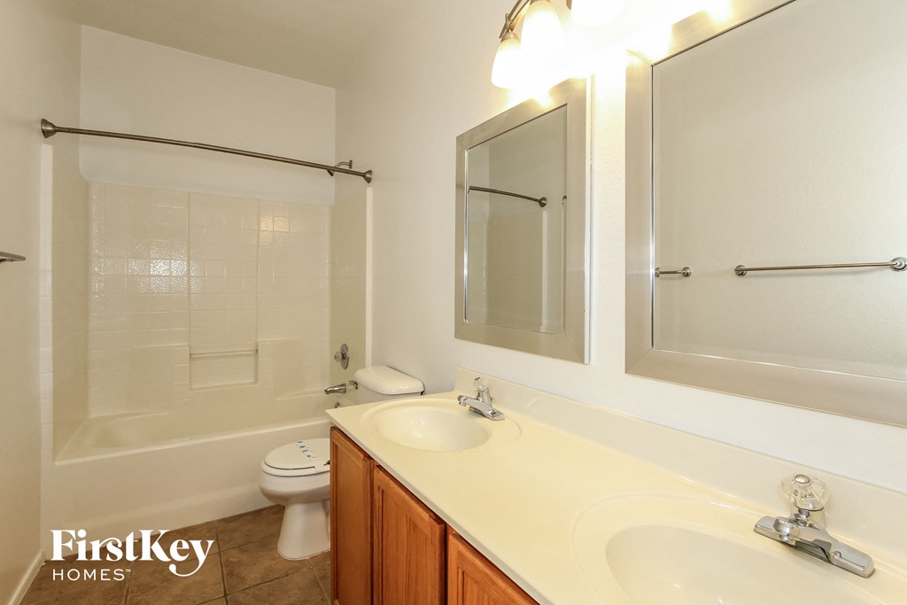 a bathroom with a sink and a shower and a toilet