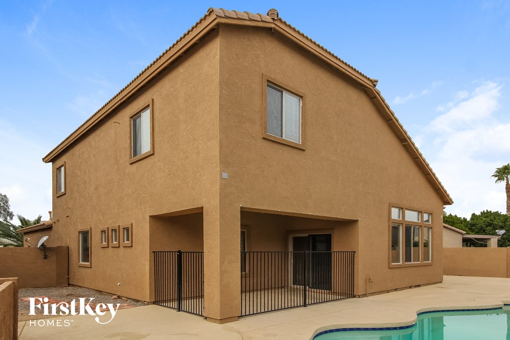 a large brown building with a pool in front of it