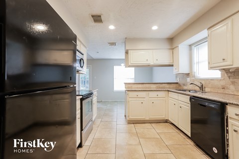 a kitchen with stainless steel appliances and white cabinets