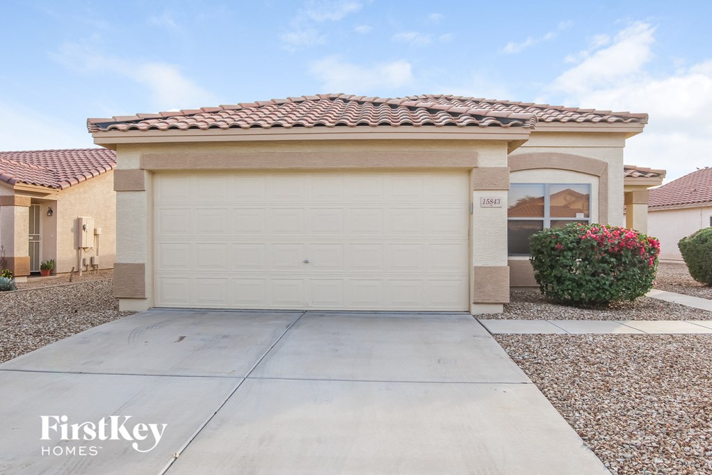 a home with a garage door and a driveway
