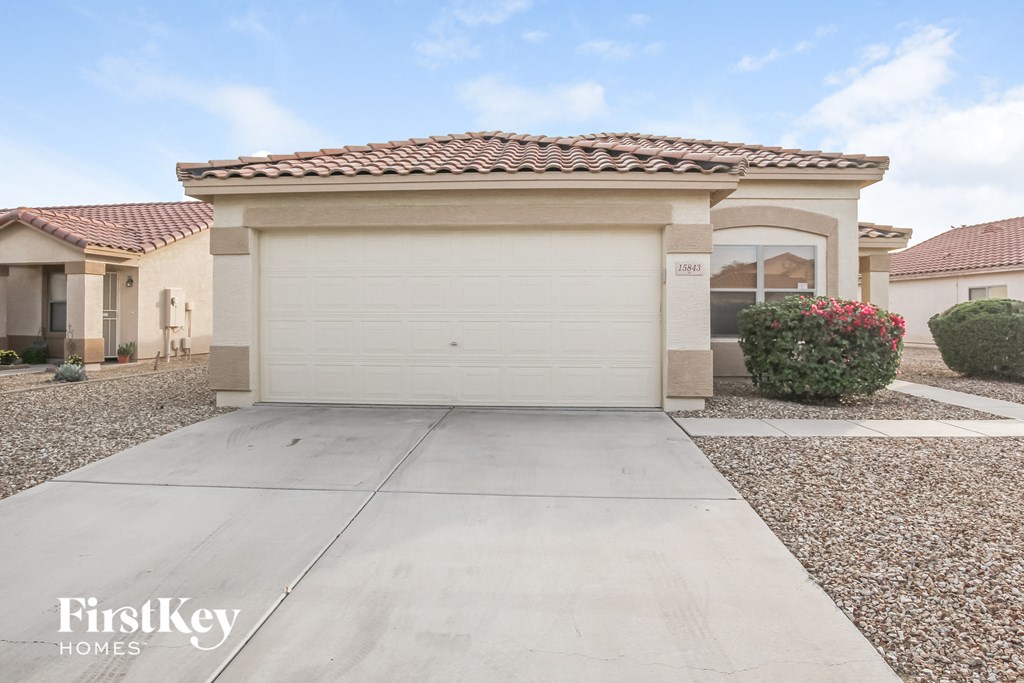 a home with a white garage door and a driveway
