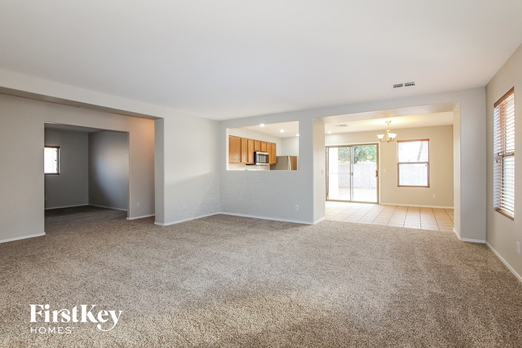 the living room and dining room of an empty house