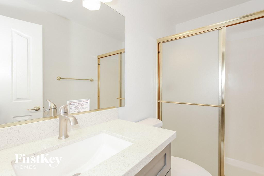 a bathroom with a sink and a shower and a toilet