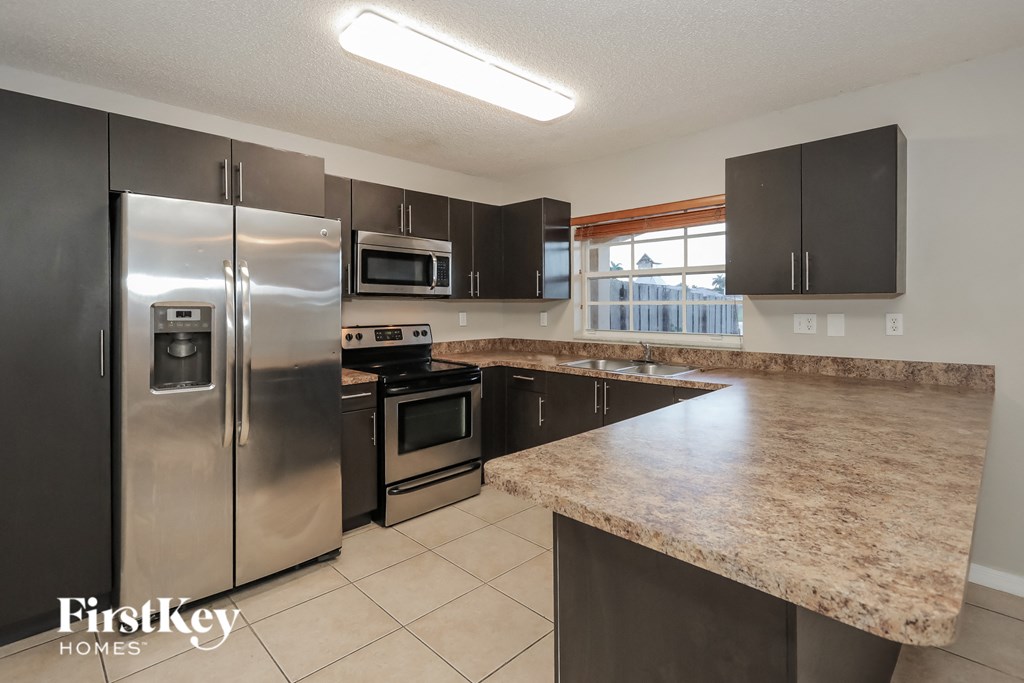 a kitchen with stainless steel appliances and a marble counter top