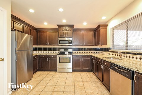 a kitchen with wooden cabinets and stainless steel appliances