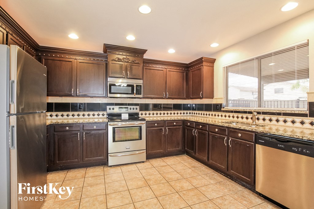a kitchen with wooden cabinets and stainless steel appliances