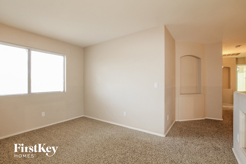 an empty bedroom with a closet and a window