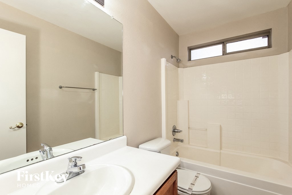 a bathroom with a sink and a shower and a toilet