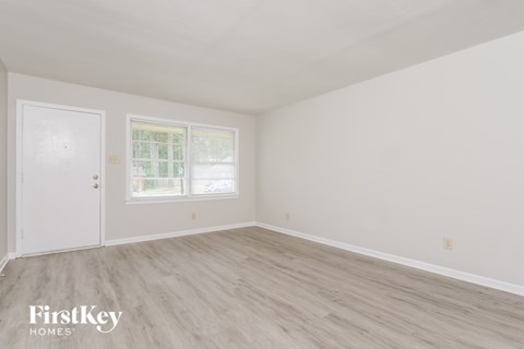 A room with a white door and a window with a white frame.