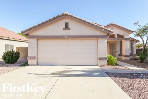 a home with a white garage door and a driveway